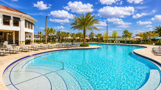Storey Lake resort clubhouse pool lined with loungers and palms