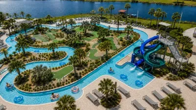 Resort-style lazy river, waterslide, and waterfront views