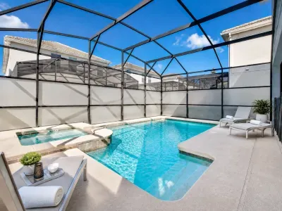 Private screened pool & spa with sunny loungers for a resort-style stay