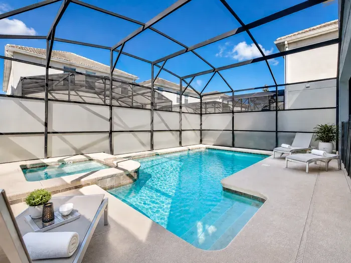 Private screened pool & spa with sunny loungers for a resort-style stay
