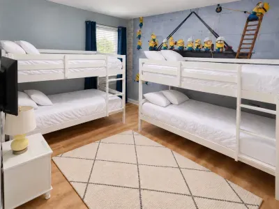 Playful bunk room for 6 with fun mural and bright, family-friendly style
