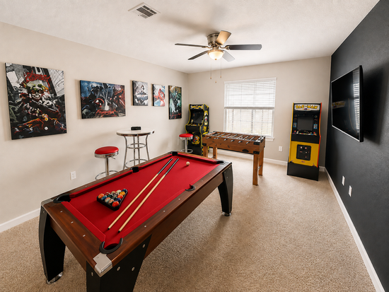 Second angle of the game room with pool table, foosball and Pac-Man arcade