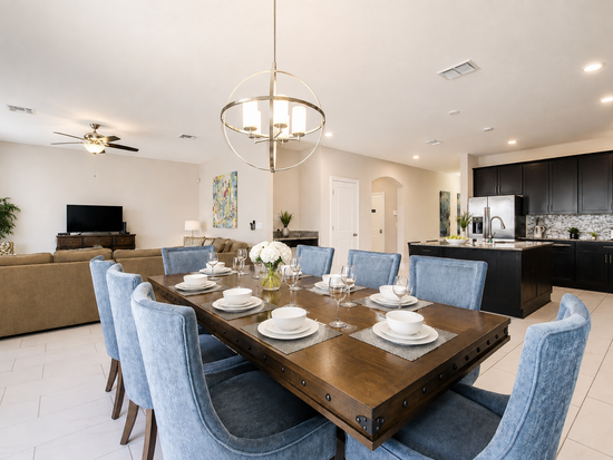 Dining table set for 8 with island seating for 4 more, open to the kitchen