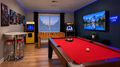 Epic game room with pool, foosball, arcades, and big-screen TV