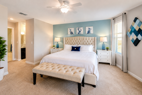 King suite with tufted headboard and teal accent wall