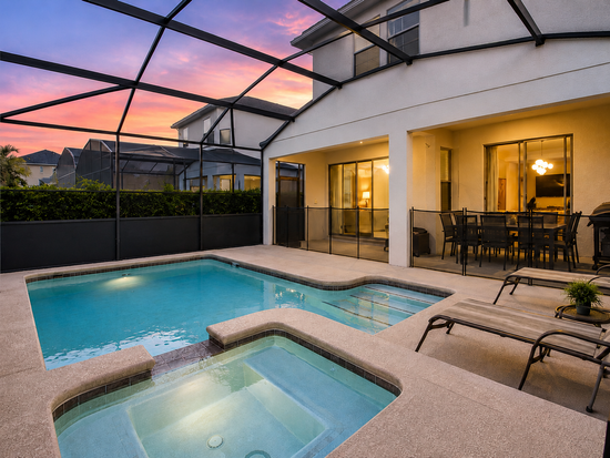 Private screened pool and spillover spa at the villa at sunset